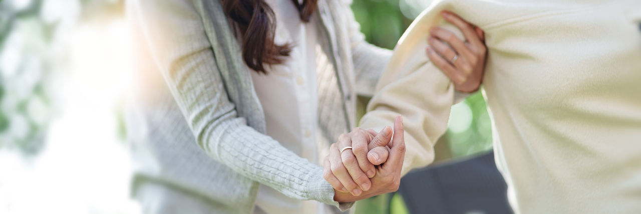 nurse taking hand of woman